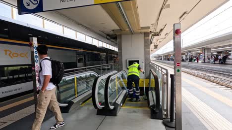 people using escalator at florence train station