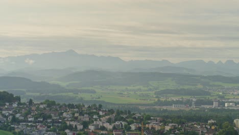 small town in the country with the alps in the background