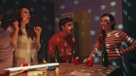 woman throwing ball beer cups having failed. friends playing alcohol ping pong