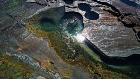 figure 8 pool, australia, drone circles girl floating in pool