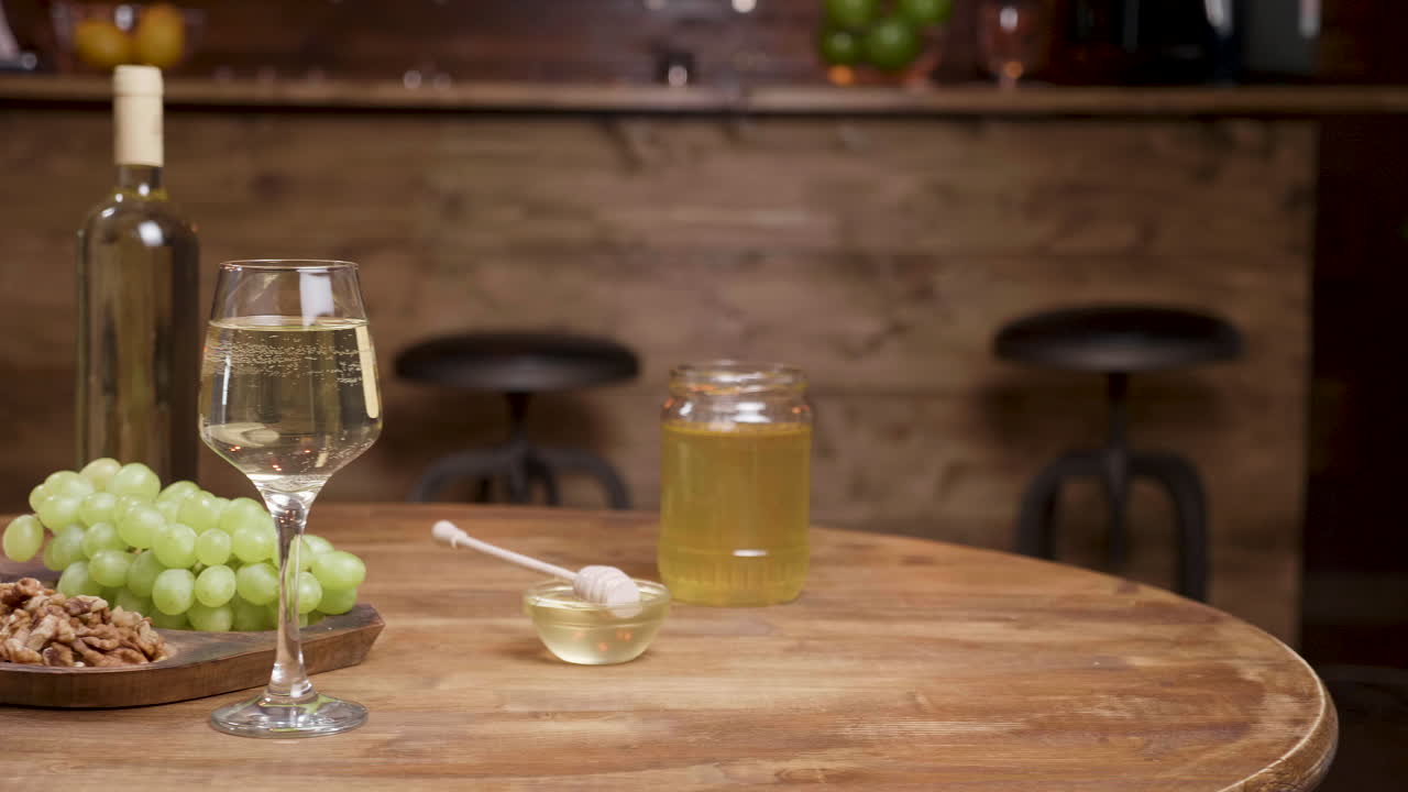 Still life with wine, cheese, grapes and honey