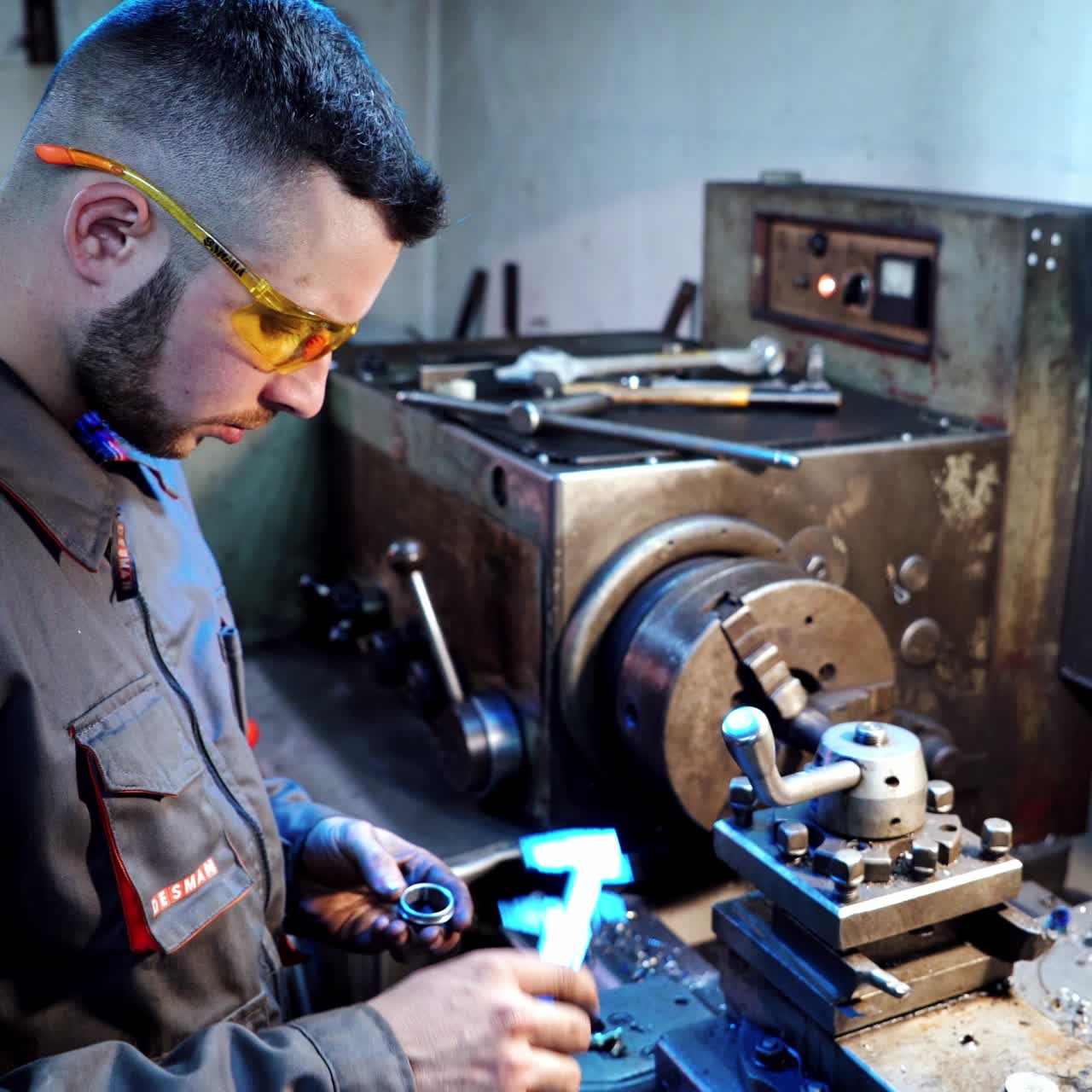 Worker measuring with caliper