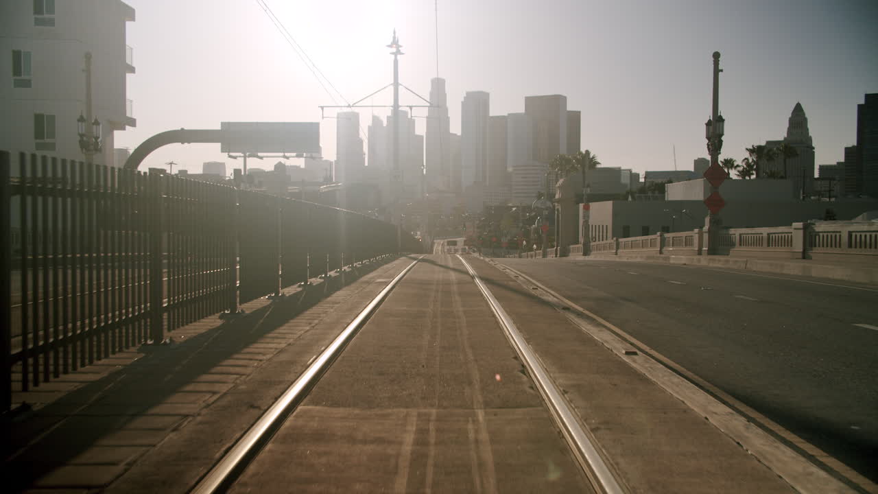 Train Tracks Leading Towards a Hazy City Skyline