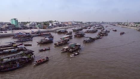 The-aerial-arc-shot-of-a-floating-market-at-Cai-Rang,-Vietnam,-Asia,-Can-Tho-river