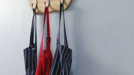 various aprons hanging on hook 4k