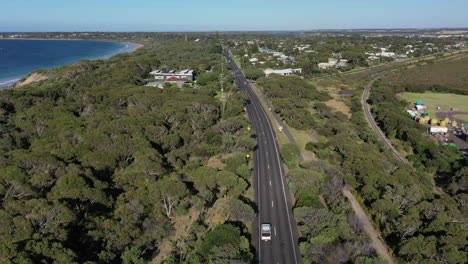 low aerial follows traffic on bellarine hwy in ocean grove, australia