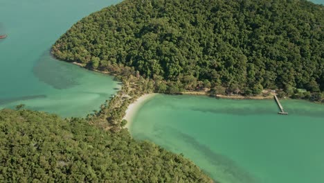 slow orbit wide angle of beautiful tropical islands with white sand beach and sand bar with palms