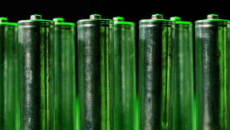 silver batteries aa and aaa in neon light close-up. double-a battery is a standard size single cell cylindrical dry battery. batteries are common in portable electronic devices. an aa battery is composed of a single electrochemical cell that may be either a primary battery or a rechargeable battery.