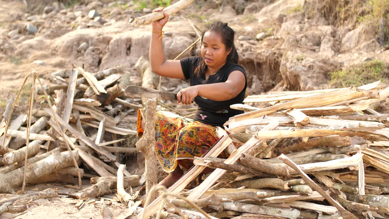 Woman chopping firewood