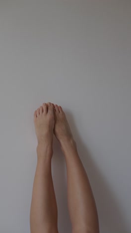 Feet and legs against a wall