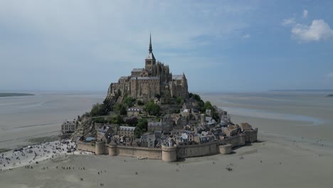 dramatic blue sky framing mont st michael tidal island normandy france tide out drone,aerial