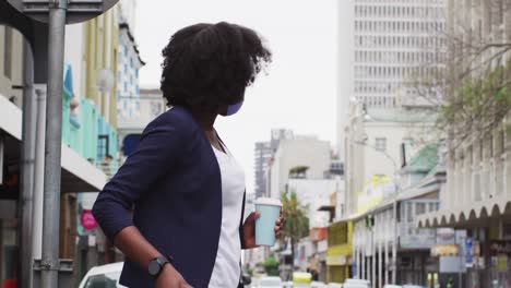 african american woman wearing face mask in street