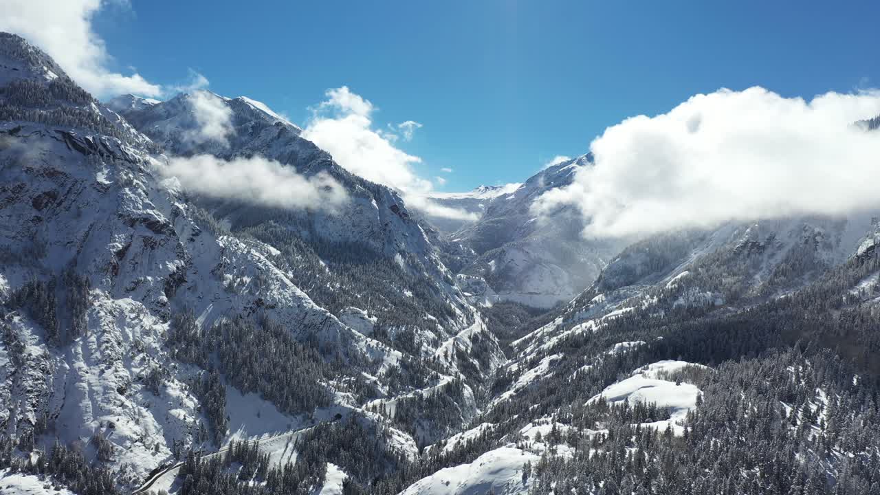 Aerial View, dyllic Sunny Winter Day in Snowy Winter Landscape and Valley Road, Drone Shot