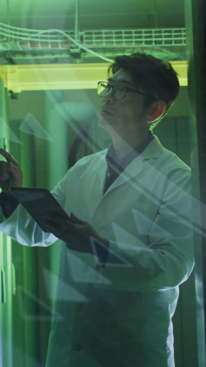 Vertical video: Tech tapping tablet and verifying rack data, green triangles reflecting on panel