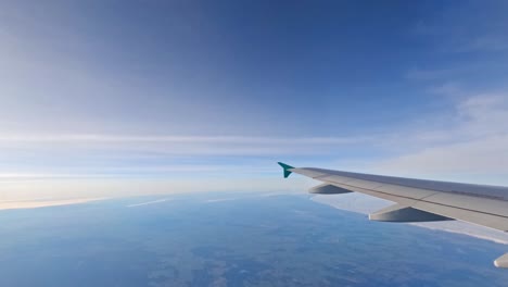 plane ascends over clouds, time lapse view through side window