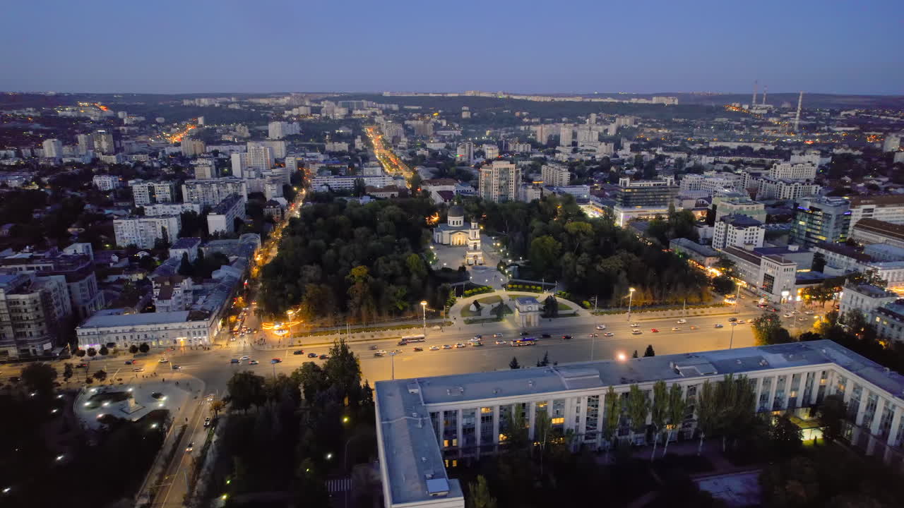 Aerial drone view of Chisinau downtown at evening, Moldova. View of Central Park, Cathedral, Goverment and a lot of greenery, buildings, illumination