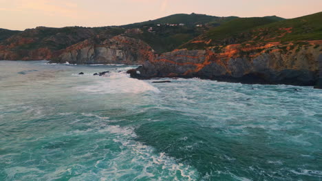 evening rocky hills landscape aerial. foaming sea splashing on rough rock cliffs