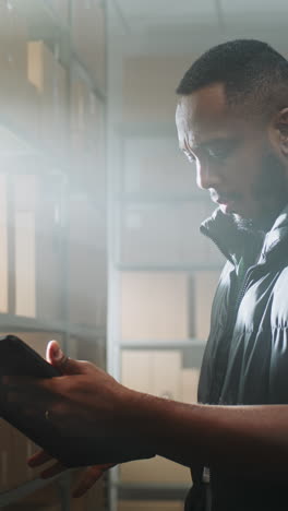 warehouse worker checking inventory on tablet