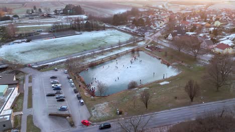 People-Ice-Skating-On-A-Lake-In-Winter---Aerial-Drone-Shot