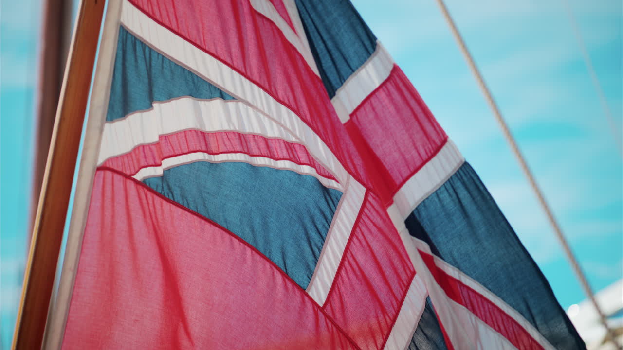 The Red Ensign British marine flag on a boat docked in the port of Cannes, France