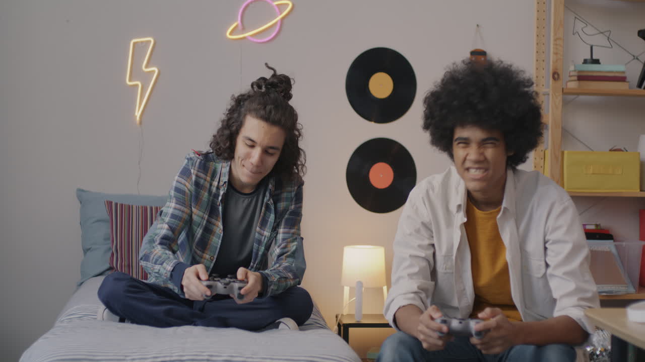 Teenagers Playing Video Games in Bedroom
