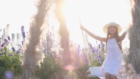 a young lady in a white style is swinging on a beautiful swing in the middle of a field a young lady in a white style is swinging on a beautiful swing in the middle of a field delight in beauty photo session in lavender