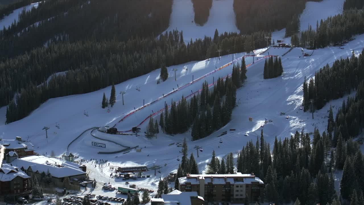 Copper Mountain Ski Resort aerial drone view chairlifts gondola halfpipe competition center village Ikon Pass Alterra snowboarding skiing early morning winter solstice December fresh snow static shot