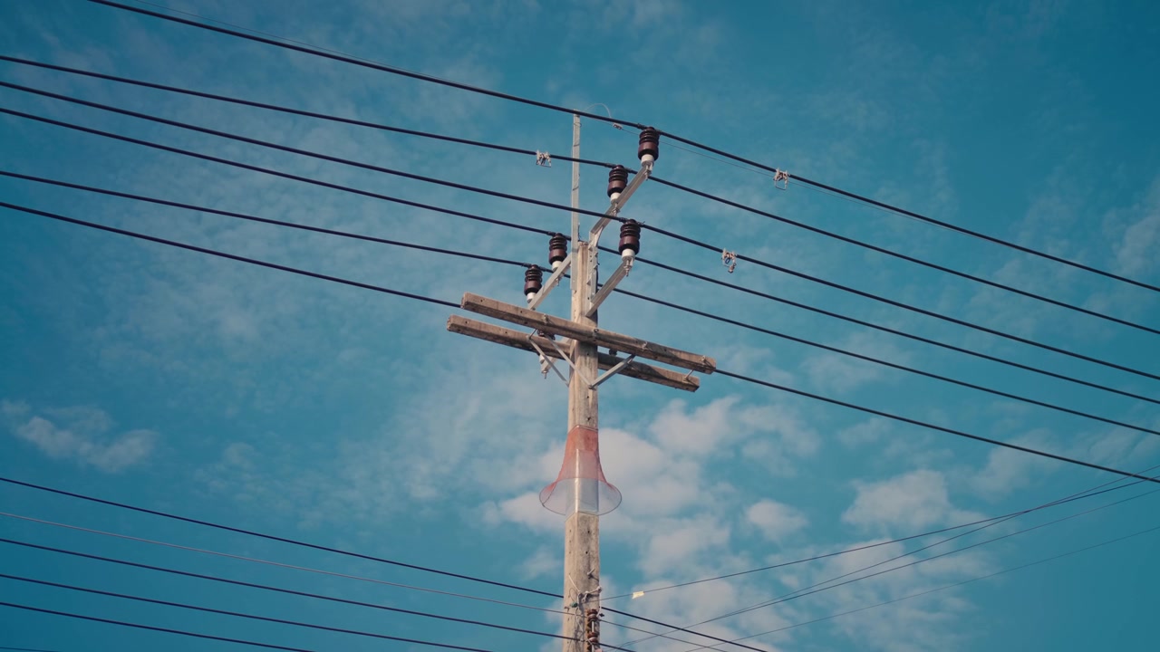 Low angle of wooden utility pole against blue sky in Koh Phangan