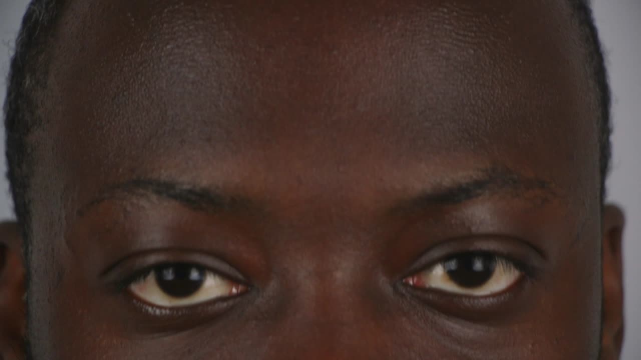 Close Up Of Black Male Looking Up And Staring Into Camera