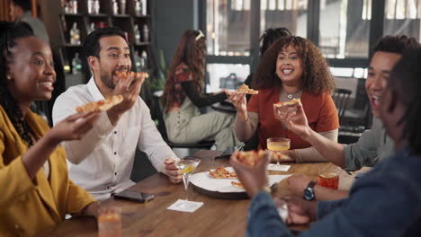 friends enjoying pizza and drinks at a bar