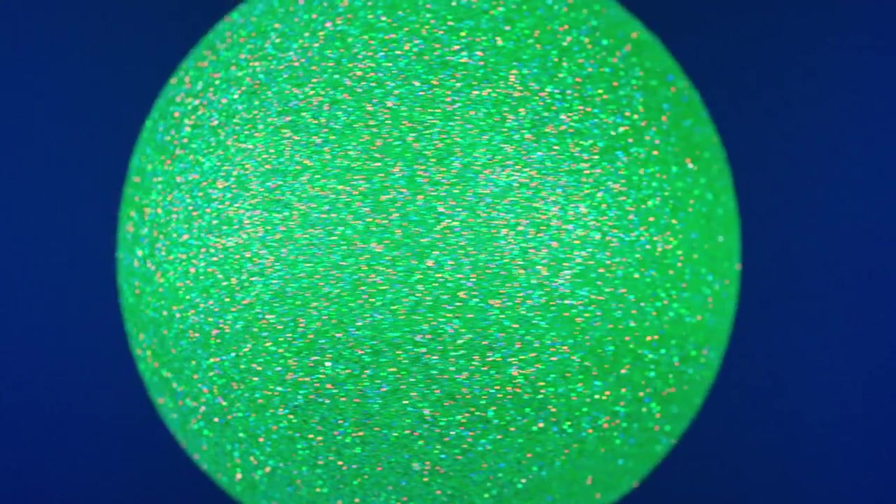 Abstract Green Glitter Sphere Slowly Rotating on Blue Background