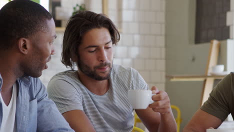 Three-Male-Friends-Meeting-In-Coffee-Shop-Shot-In-Slow-Motion