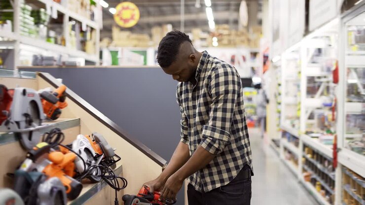 African american buyer selecting tool in building and repair shot indoors
