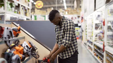 African-american-buyer-selecting-tool-in-building-and-repair-shot-indoors