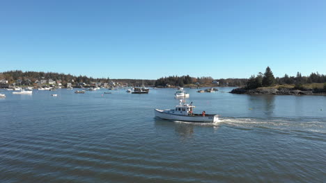 aerial fly by follow drone footage of lobster boat at maine coast, vinalhaven, fox islands, knox county, maine, usa