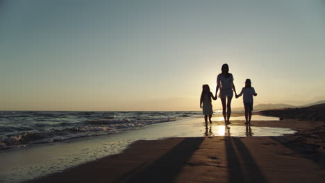 family sunset beach walk