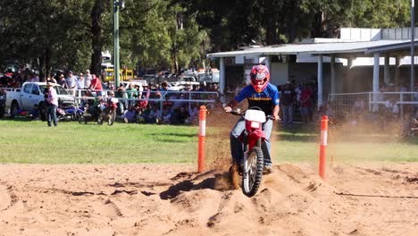 motorcyclist performing maneuvers on a sandy course