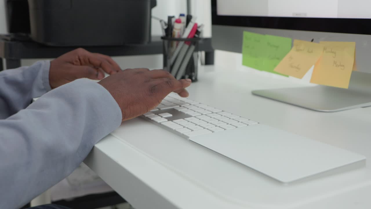 Black Male Typing On Keyboard In Home Office