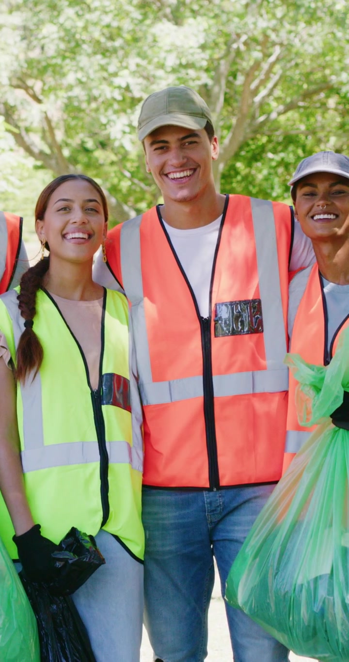 Group of Diverse Volunteers Smiling Together After Park Cleanup