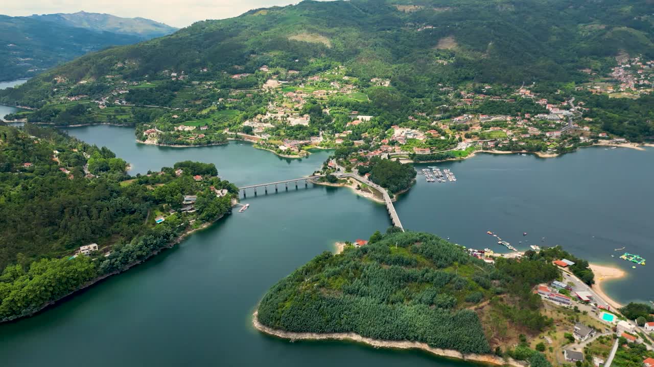 Aerial Footage of Cani&ccedil;ada's Bridge Over Caldo River, Ger&ecirc;s, Northern Portugal, bathed in Sunshine with Reflective Lake Views