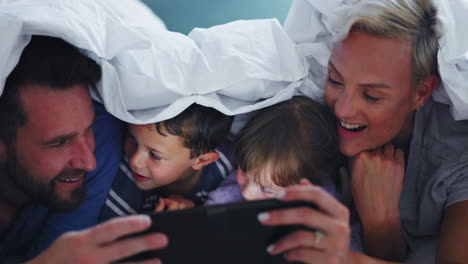 mom, dad and children with tablet