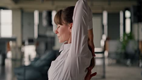 woman stretching in office