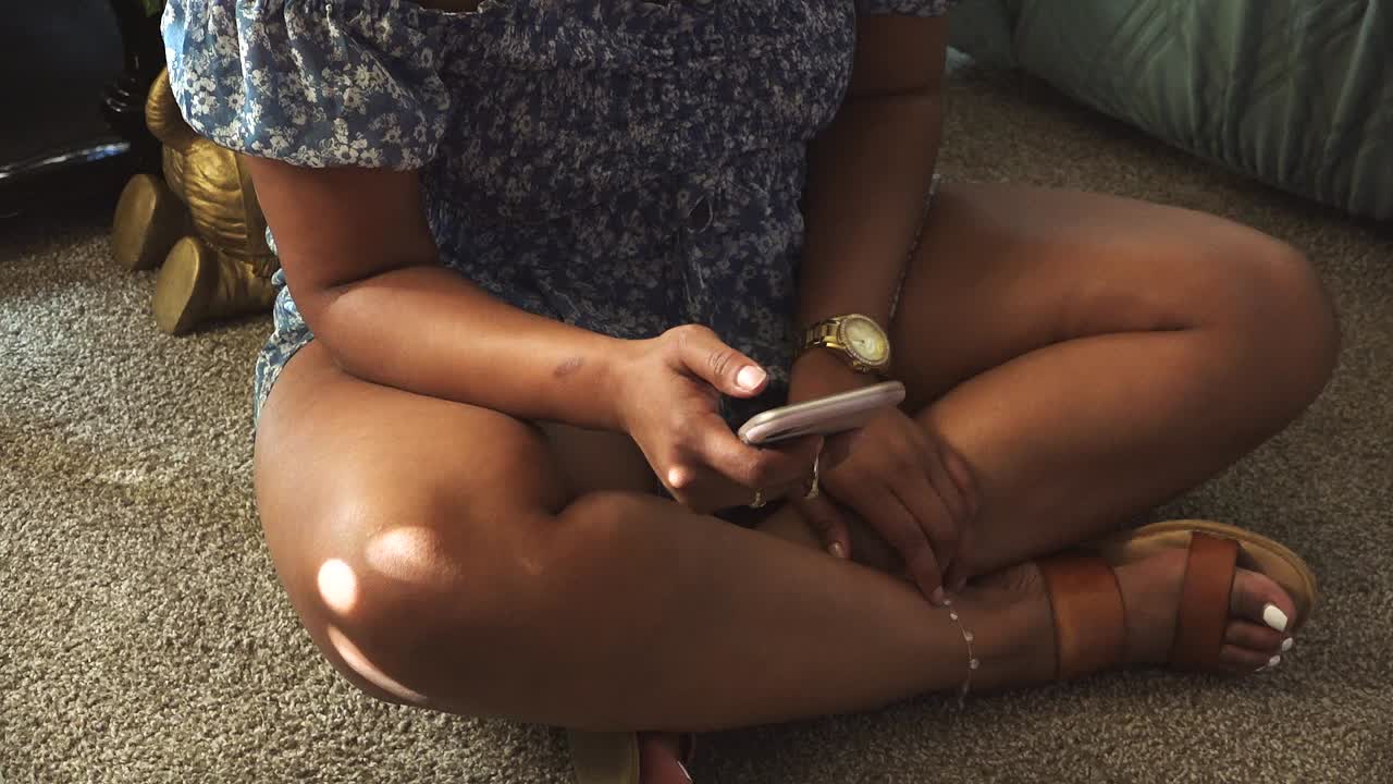 High angle view of female millennial scrolling on phone