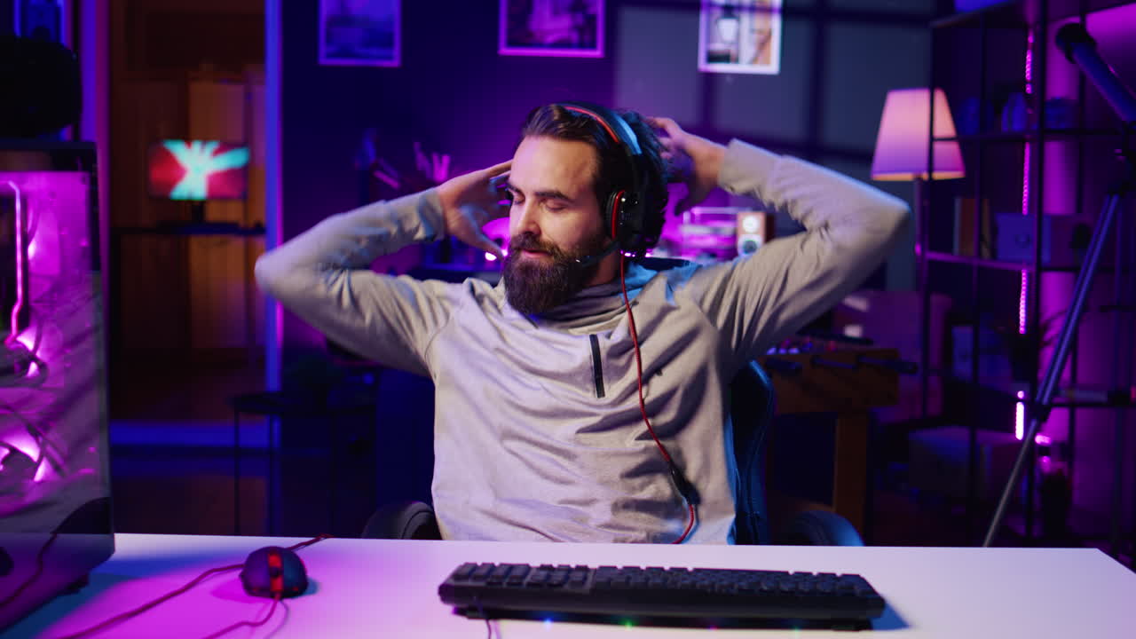 Gamer in neon lit home feeling upset after losing against opponent in online esports competition