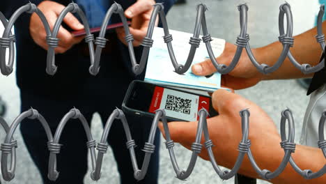 alambre de púas contra las manos que sostienen el pasaporte y usan teléfonos inteligentes
