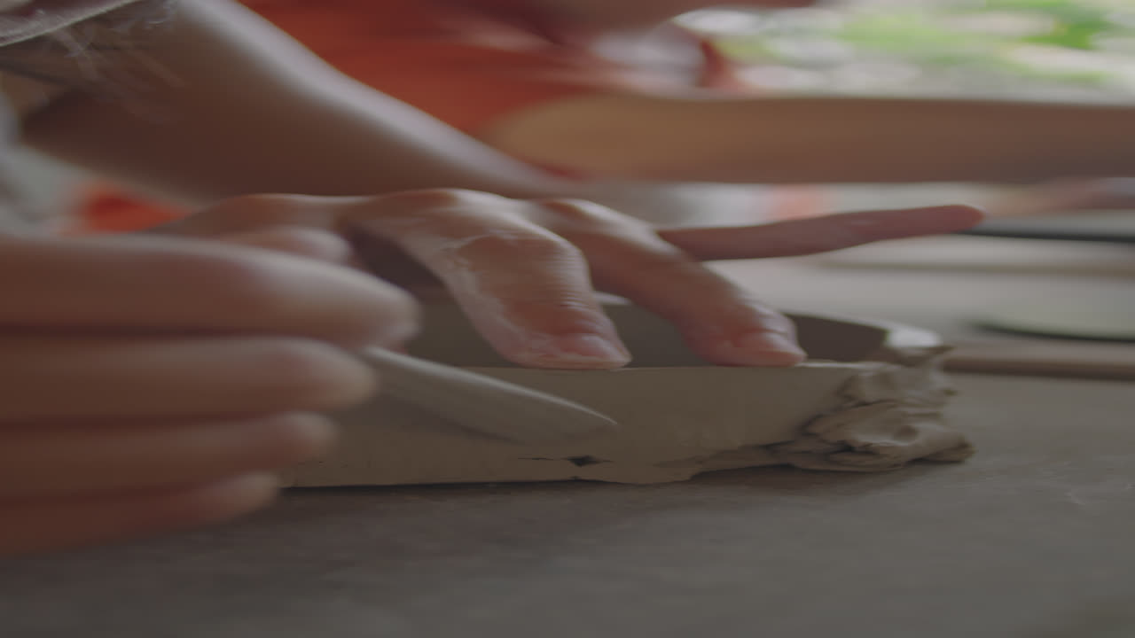 Hands of Artisan Making Ceramics with Pottery Rib