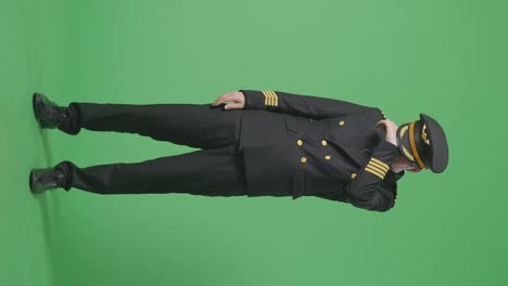 full body of asian man pilot wiping the sweat and being tired while standing in the green screen background studio