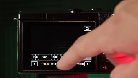 adjusting the shutter speed of a professional mirrorless camera, very close up view