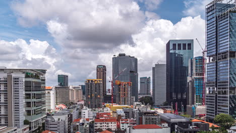 large white clouds move above downtown singapore skyline