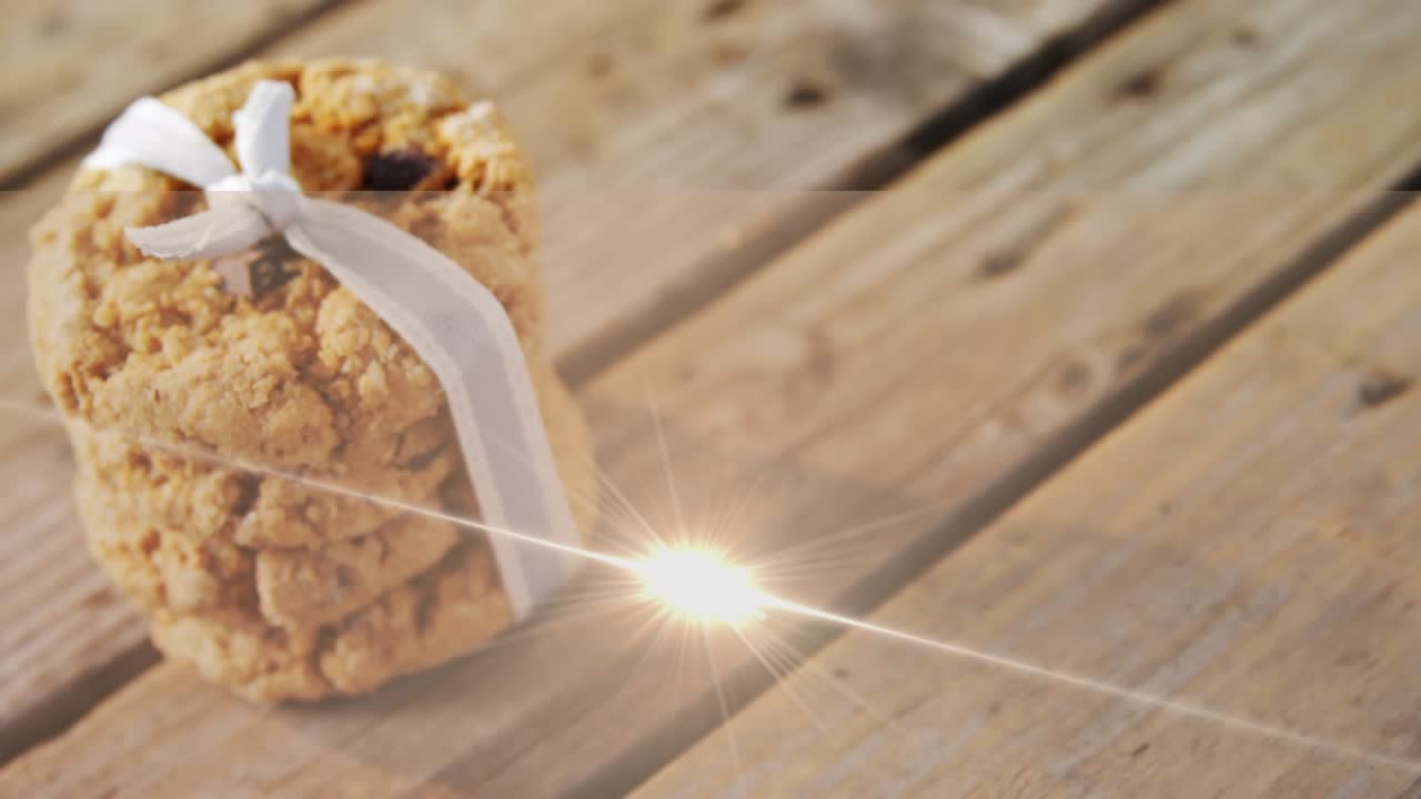 Animation of light moving over christmas cookies on wooden surface